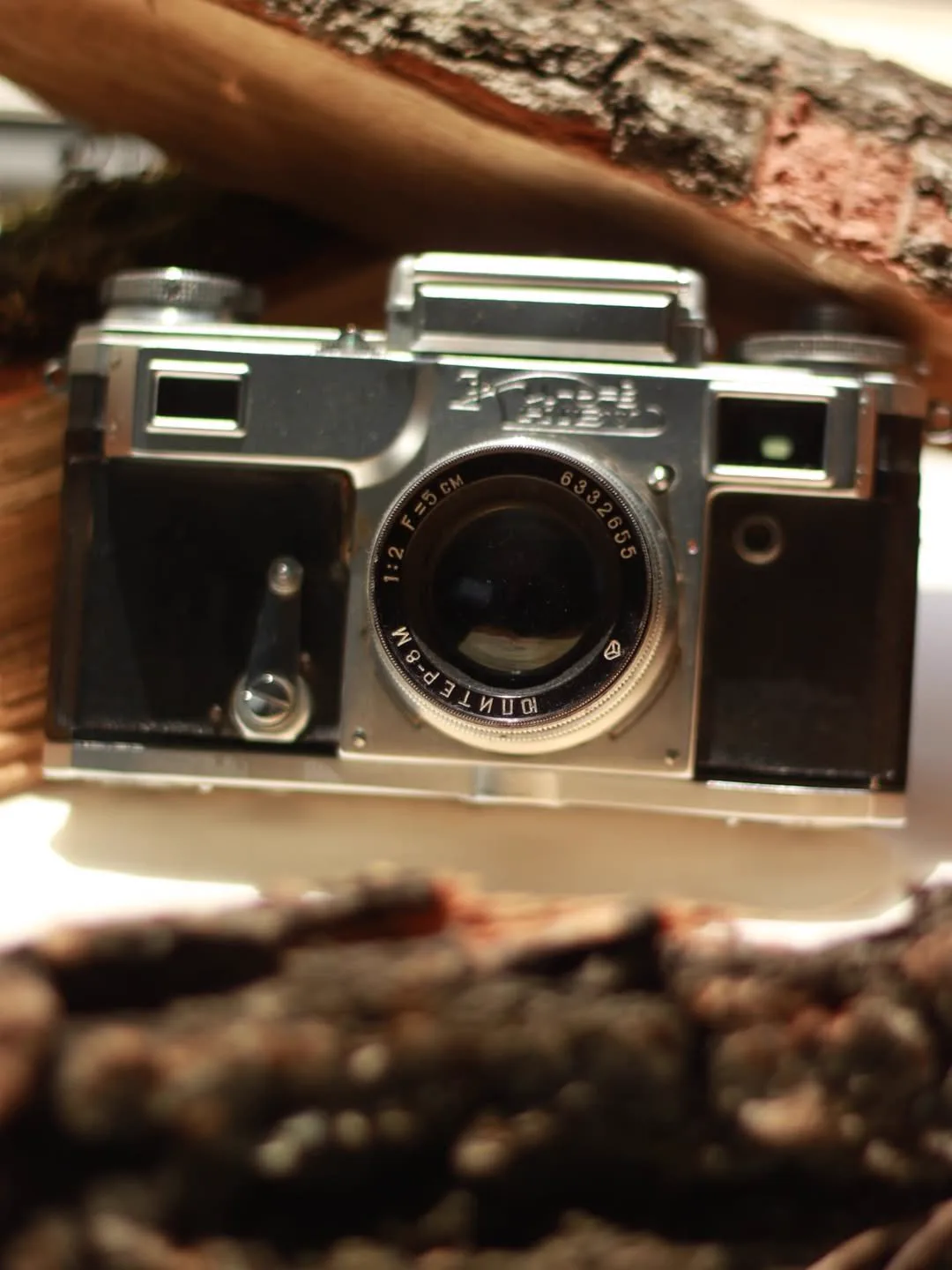 A vintage camera among pieces of wood